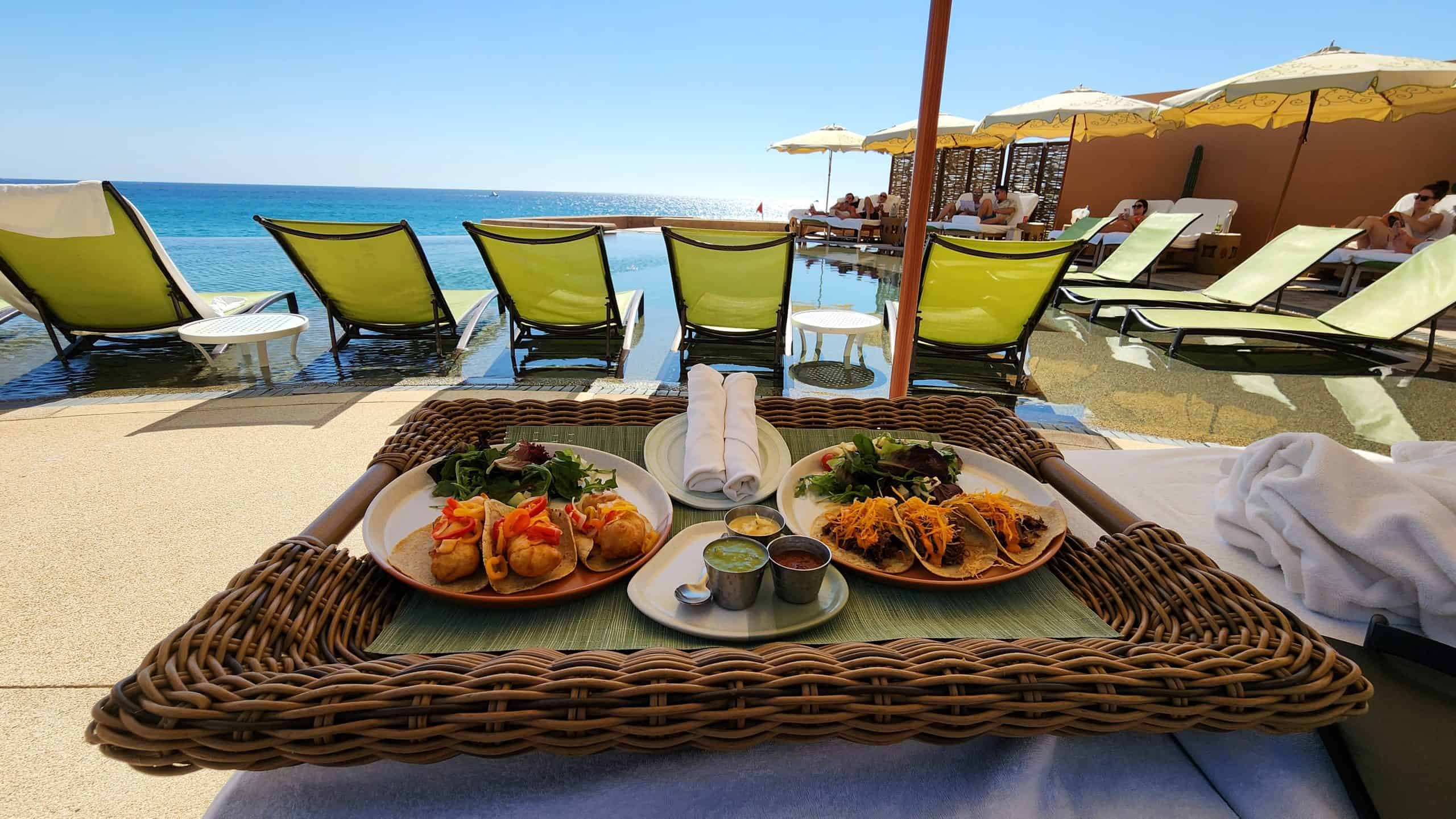A tray with lunch dishes by the adult pool